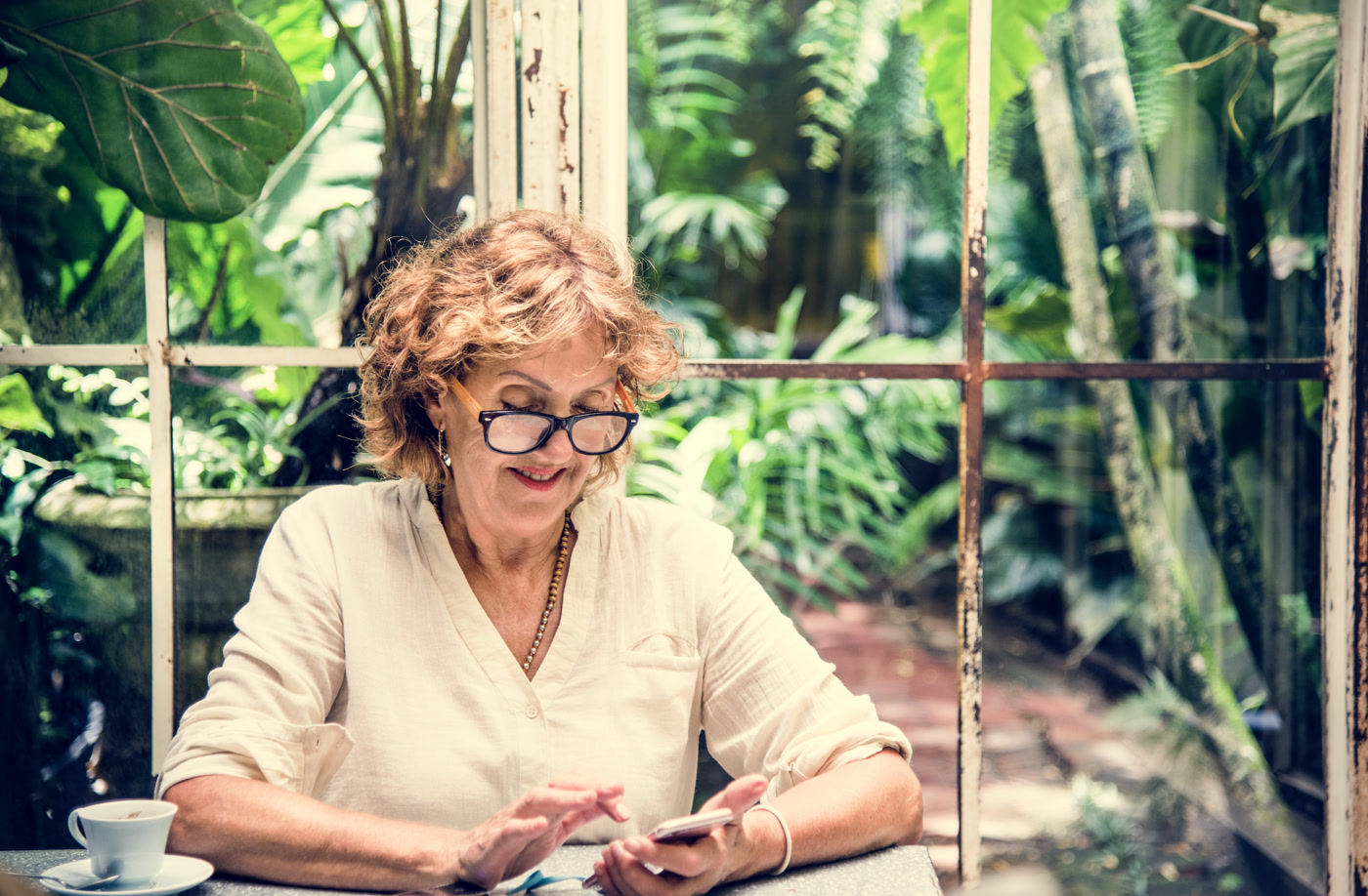 Small business owner smiling at her phone